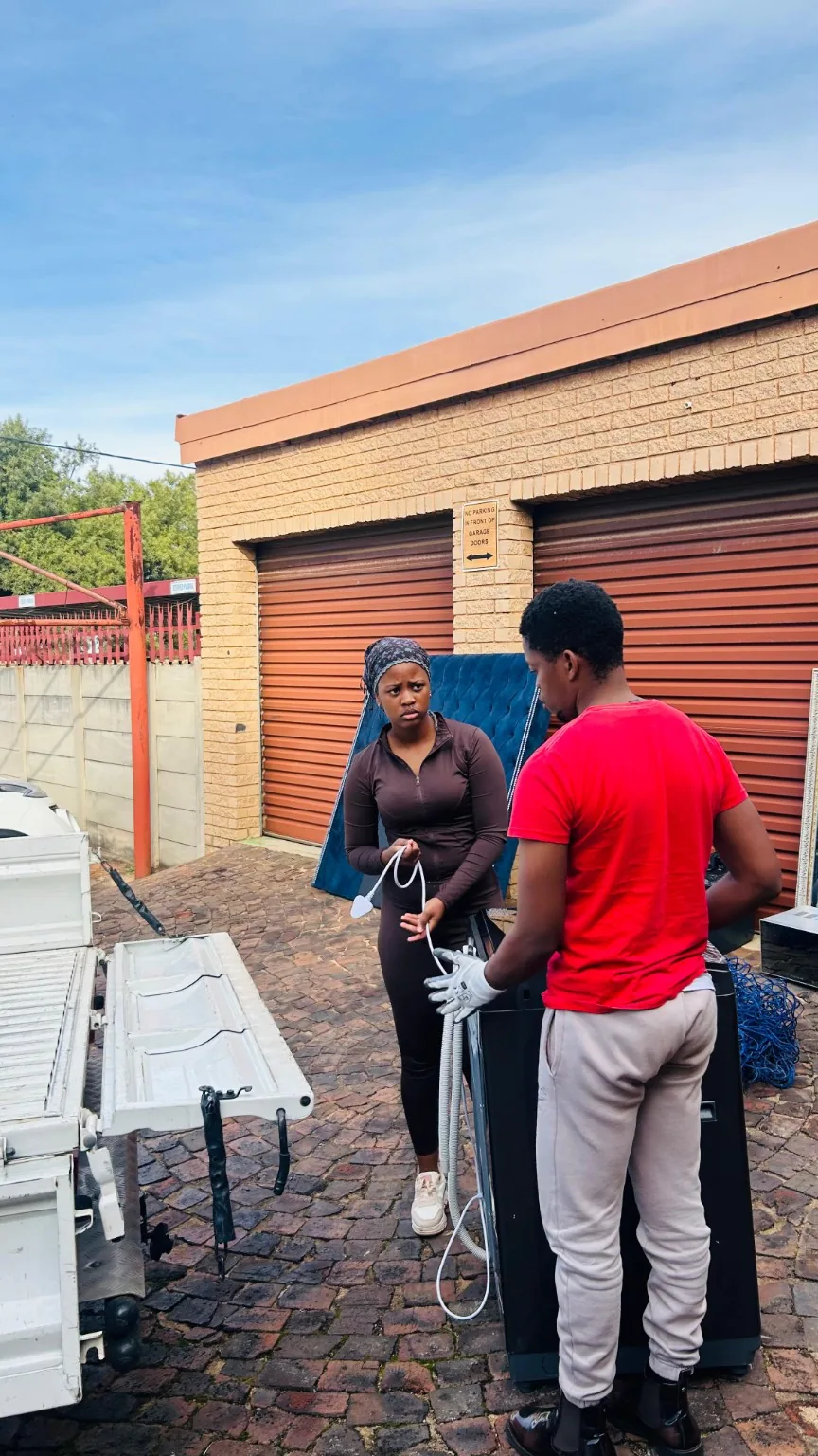 Moving team handling furniture beside a vehicle